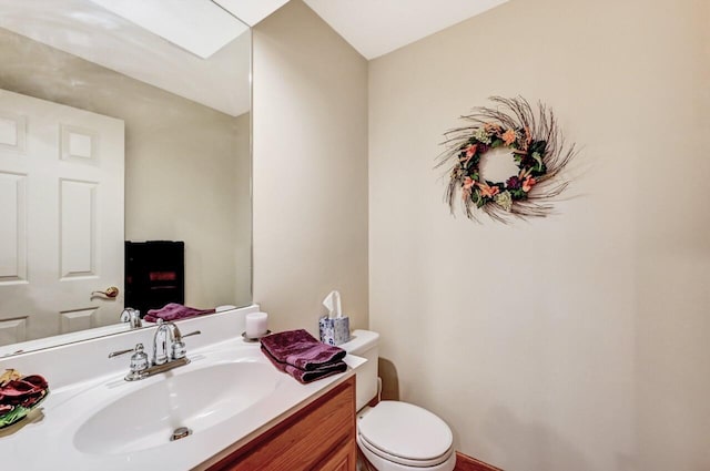 half bath with vanity and toilet