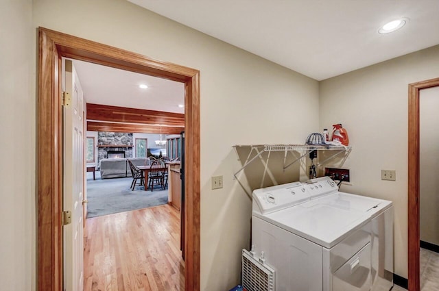 clothes washing area with independent washer and dryer, recessed lighting, laundry area, and baseboards
