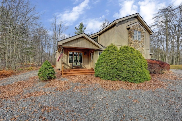 view of front of home featuring a porch and stone siding