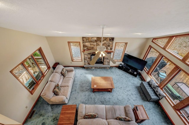 living area with baseboards, carpet, and ceiling fan