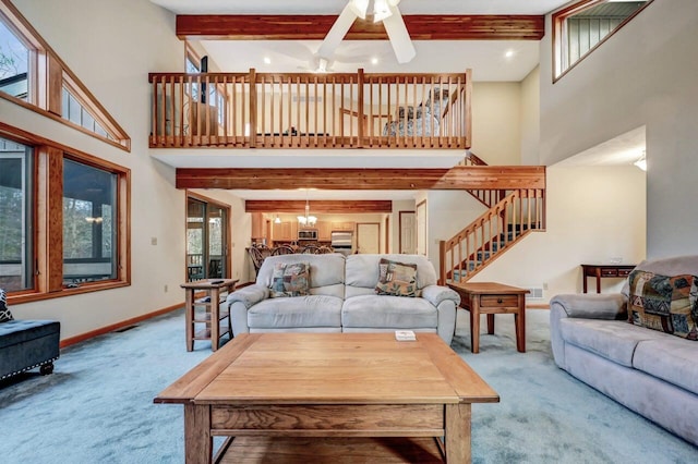 living area featuring carpet flooring, stairs, baseboards, and beam ceiling