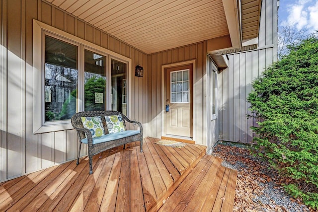 property entrance featuring covered porch and board and batten siding
