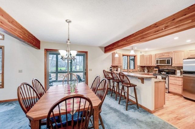 dining room with recessed lighting, baseboards, beam ceiling, and a chandelier