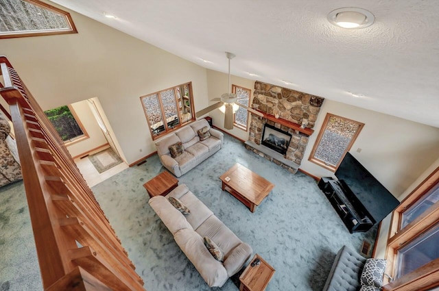 carpeted living room featuring a fireplace and vaulted ceiling