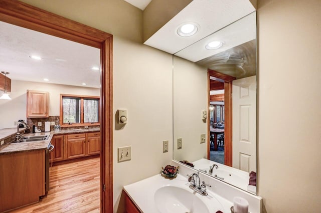 bathroom with vanity, recessed lighting, and wood finished floors