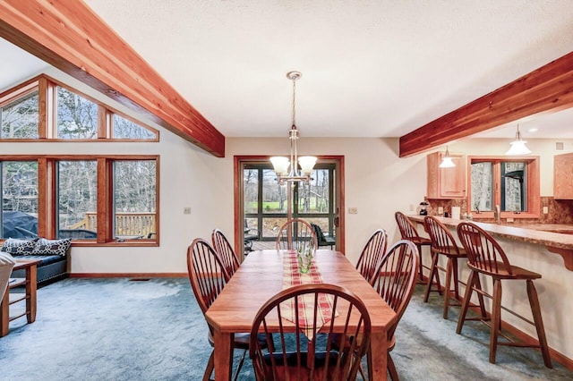 dining space featuring beamed ceiling, a chandelier, and carpet