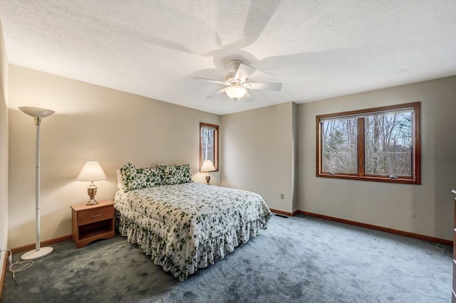 carpeted bedroom featuring baseboards, multiple windows, a textured ceiling, and ceiling fan