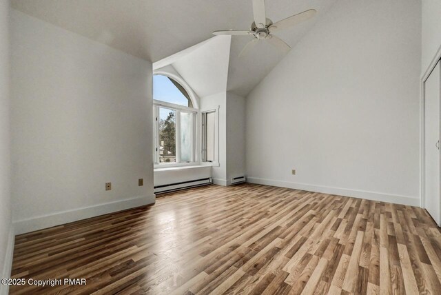 bonus room with ceiling fan, a baseboard radiator, wood-type flooring, and vaulted ceiling