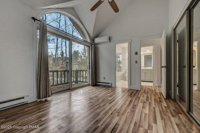 interior space featuring ceiling fan, a baseboard heating unit, high vaulted ceiling, a wall mounted AC, and wood-type flooring