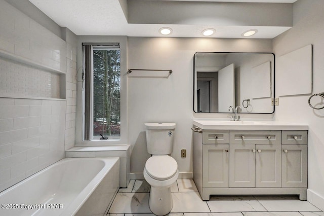 bathroom featuring a tub to relax in, toilet, and vanity