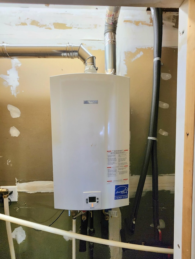 utility room featuring tankless water heater