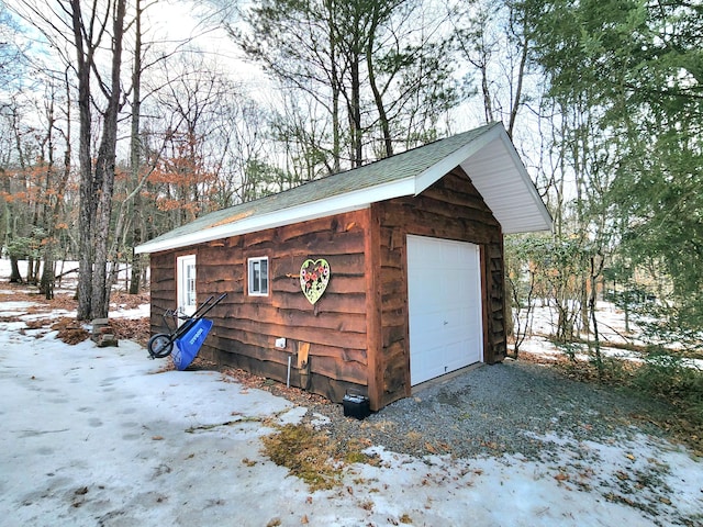 snow covered structure featuring an outdoor structure