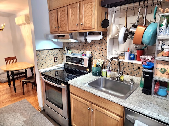 kitchen with dishwashing machine, light wood-style flooring, stainless steel electric range, a sink, and exhaust hood