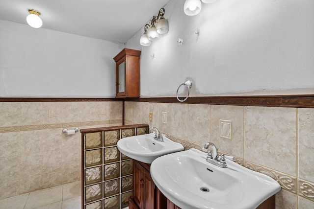 240 Timberline Dr, East Stroudsburg, PA 18301 - bathroom featuring two sinks, tile walls, and a wainscoted wall