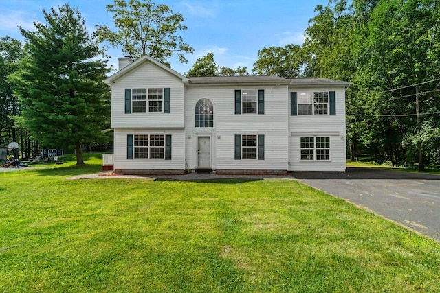 240 Timberline Dr, East Stroudsburg, PA 18301 - view of front facade featuring a chimney, a front lawn, and asphalt driveway