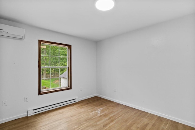 240 Timberline Dr, East Stroudsburg, PA 18301 - empty room with a baseboard radiator, an AC wall unit, and light wood-style floors