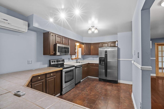 240 Timberline Dr, East Stroudsburg, PA 18301 - kitchen with stainless steel appliances, a wall unit AC, tile countertops, and dark brown cabinets