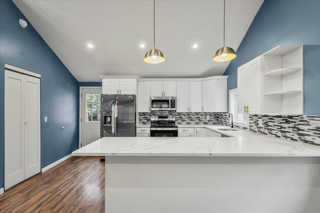 kitchen with dark wood-style flooring, a sink, white cabinets, appliances with stainless steel finishes, and backsplash