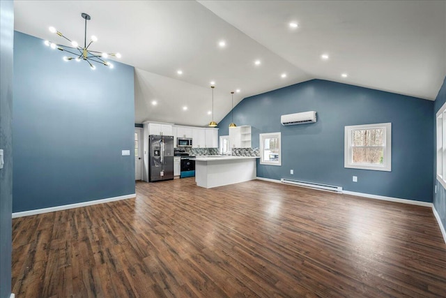 kitchen featuring open floor plan, a wall mounted air conditioner, stainless steel appliances, a baseboard heating unit, and white cabinetry