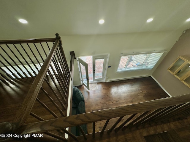 stairway featuring a baseboard radiator and wood-type flooring