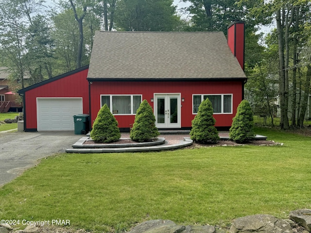 cape cod house with french doors, a garage, and a front yard