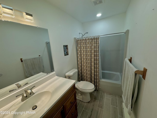 full bath featuring visible vents, wood finish floors, toilet, shower / bath combination with curtain, and vanity