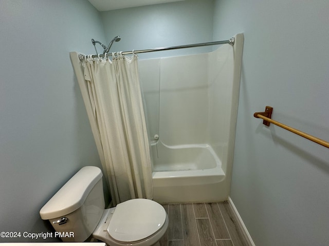 bathroom featuring shower / bath combination with curtain and toilet