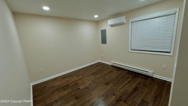 empty room featuring a baseboard radiator, a wall mounted air conditioner, dark hardwood / wood-style floors, and electric panel