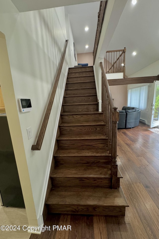 stairway with hardwood / wood-style flooring