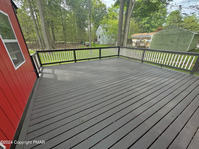 wooden terrace featuring a lawn