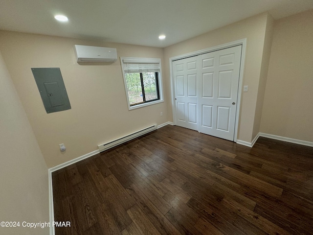 unfurnished bedroom with an AC wall unit, electric panel, dark wood-type flooring, and a baseboard radiator