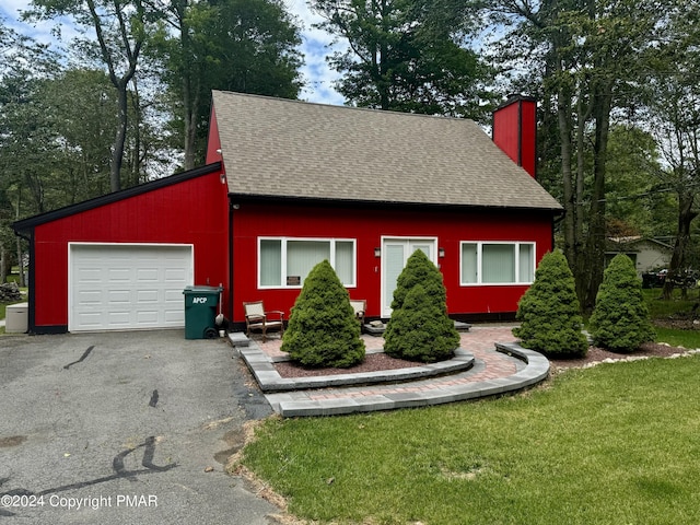 view of front of house featuring a garage and a front lawn