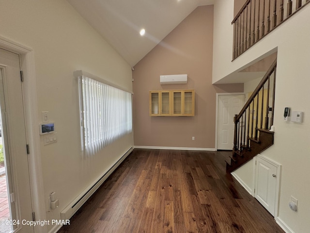 entryway featuring a baseboard heating unit, high vaulted ceiling, dark wood-style floors, and a wall mounted AC