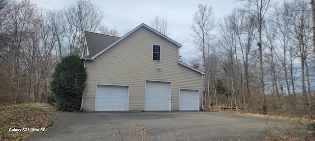 361 Great Bear Way Rd, East Stroudsburg, PA 18302 - view of side of home with driveway, an attached garage, and roof with shingles