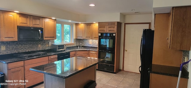 361 Great Bear Way Rd, East Stroudsburg, PA 18302 - kitchen featuring light tile patterned flooring, a warming drawer, dark stone countertops, black appliances, and decorative backsplash