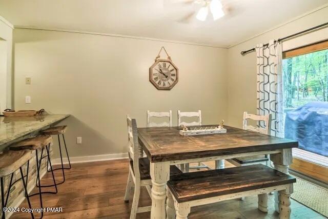 dining area featuring a ceiling fan, wood finished floors, and baseboards