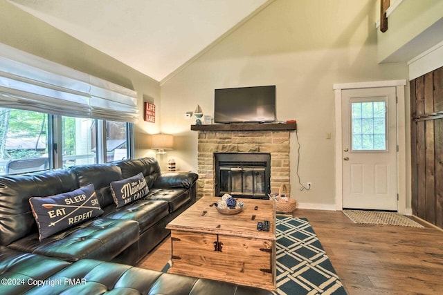 living room featuring a fireplace, high vaulted ceiling, baseboards, and wood finished floors