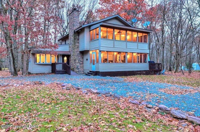 back of property featuring a sunroom