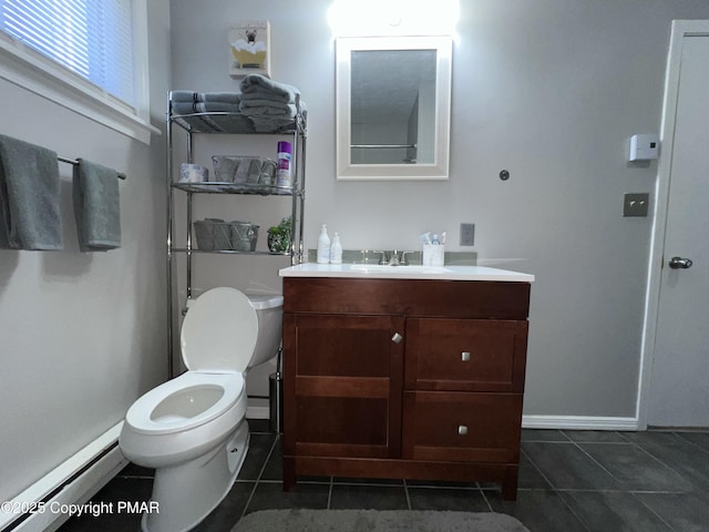 bathroom with tile patterned flooring, toilet, vanity, baseboards, and baseboard heating