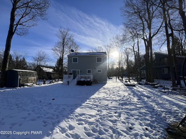 view of snow covered rear of property