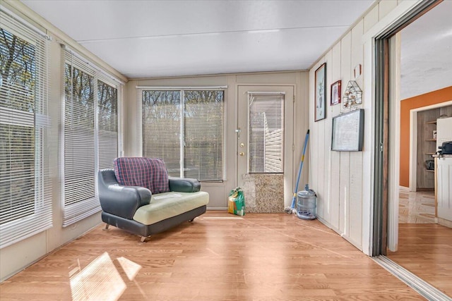 sunroom with wood finished floors and lofted ceiling