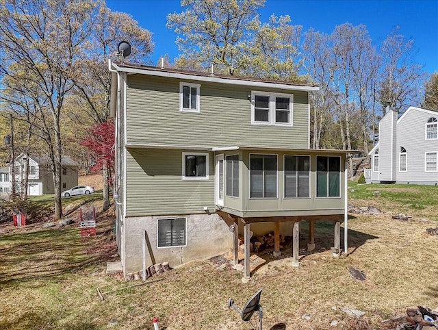 rear view of property with a sunroom
