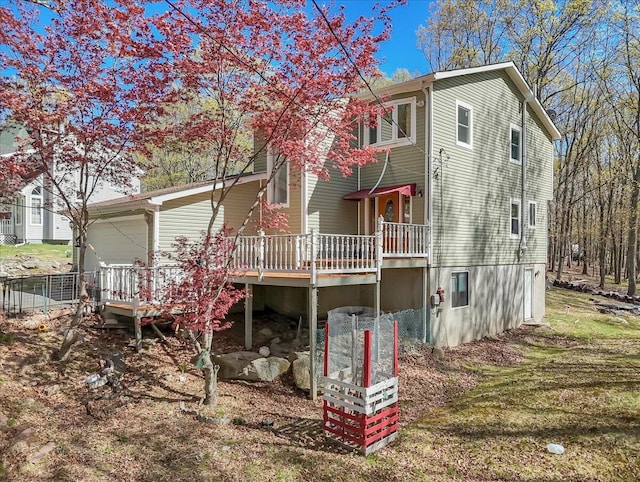 rear view of property featuring a deck