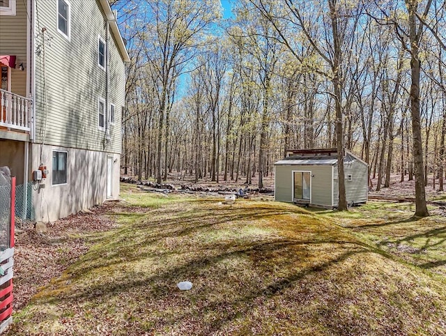 view of yard with a storage shed and an outbuilding