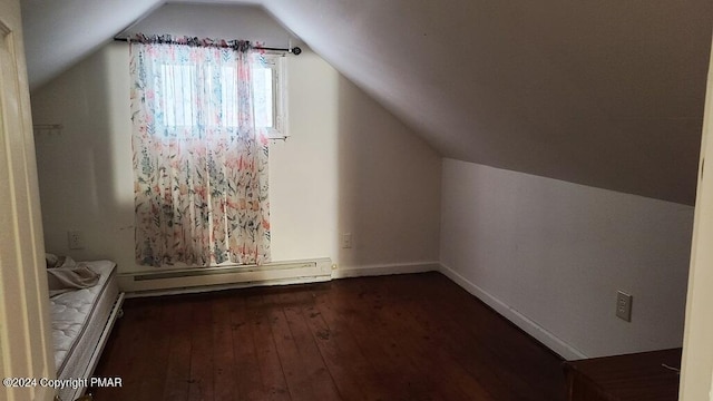 bonus room with a baseboard heating unit, hardwood / wood-style floors, lofted ceiling, and baseboards