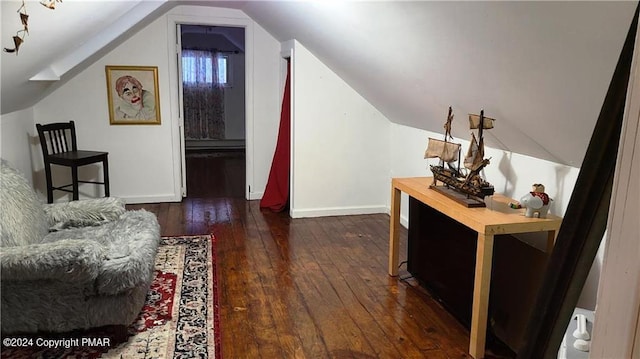 sitting room with lofted ceiling, wood-type flooring, and baseboards