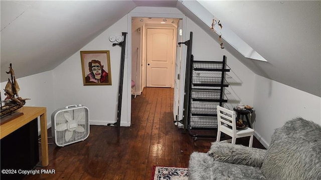 interior space with baseboards, vaulted ceiling, and hardwood / wood-style floors