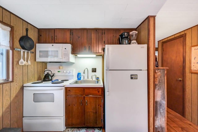 115 Alpine Ct, Pocono Pines, PA 18350 - kitchen with white appliances, wooden walls, light countertops, and brown cabinetry