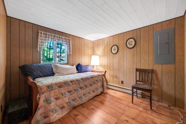 115 Alpine Ct, Pocono Pines, PA 18350 - bedroom featuring electric panel, hardwood / wood-style flooring, wooden walls, and a baseboard radiator
