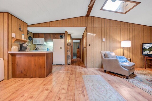 115 Alpine Ct, Pocono Pines, PA 18350 - kitchen with white appliances, a skylight, light wood finished floors, vaulted ceiling, and a peninsula